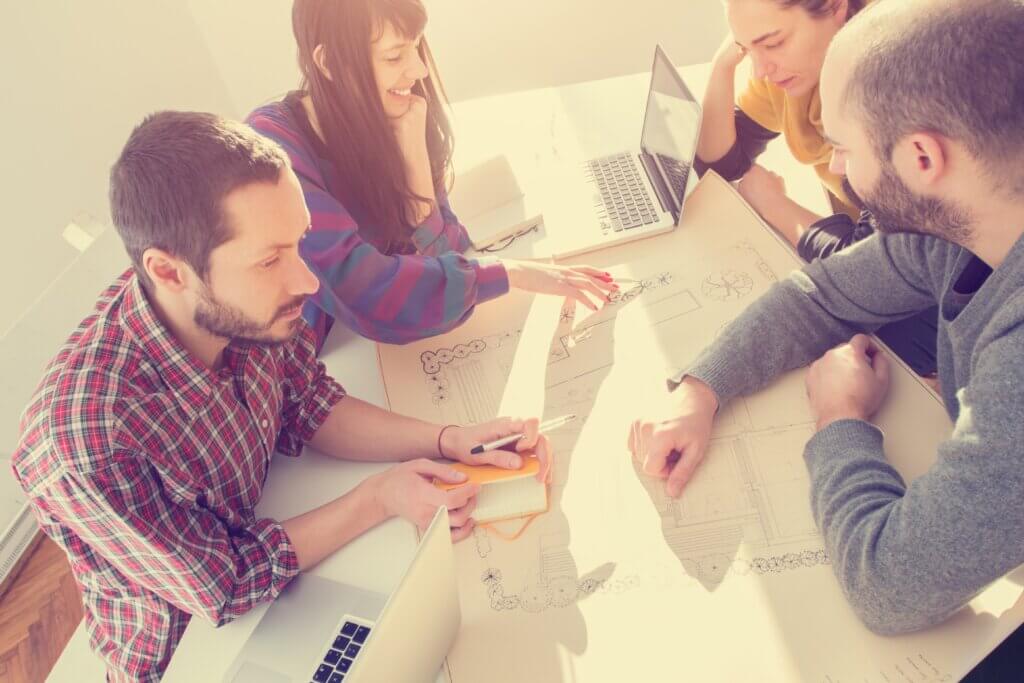 group20of20young20people20discussing20business20plans20warm20computer20drawings