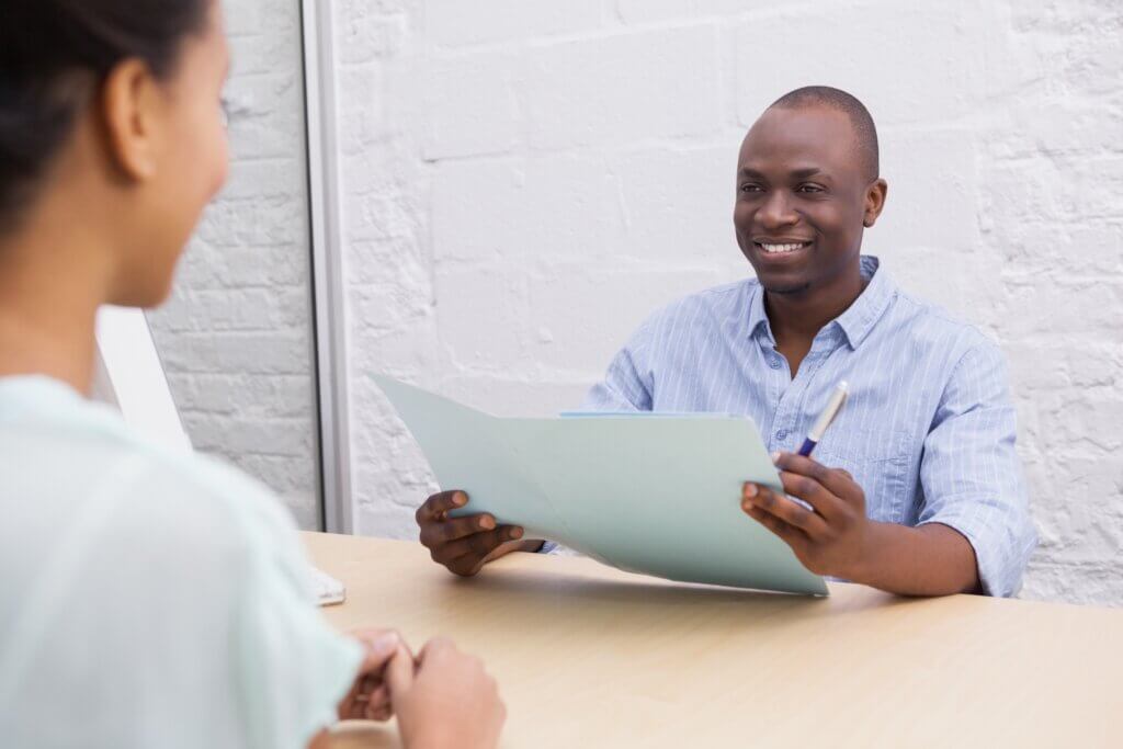 Smiling businessman holding folder during an interview